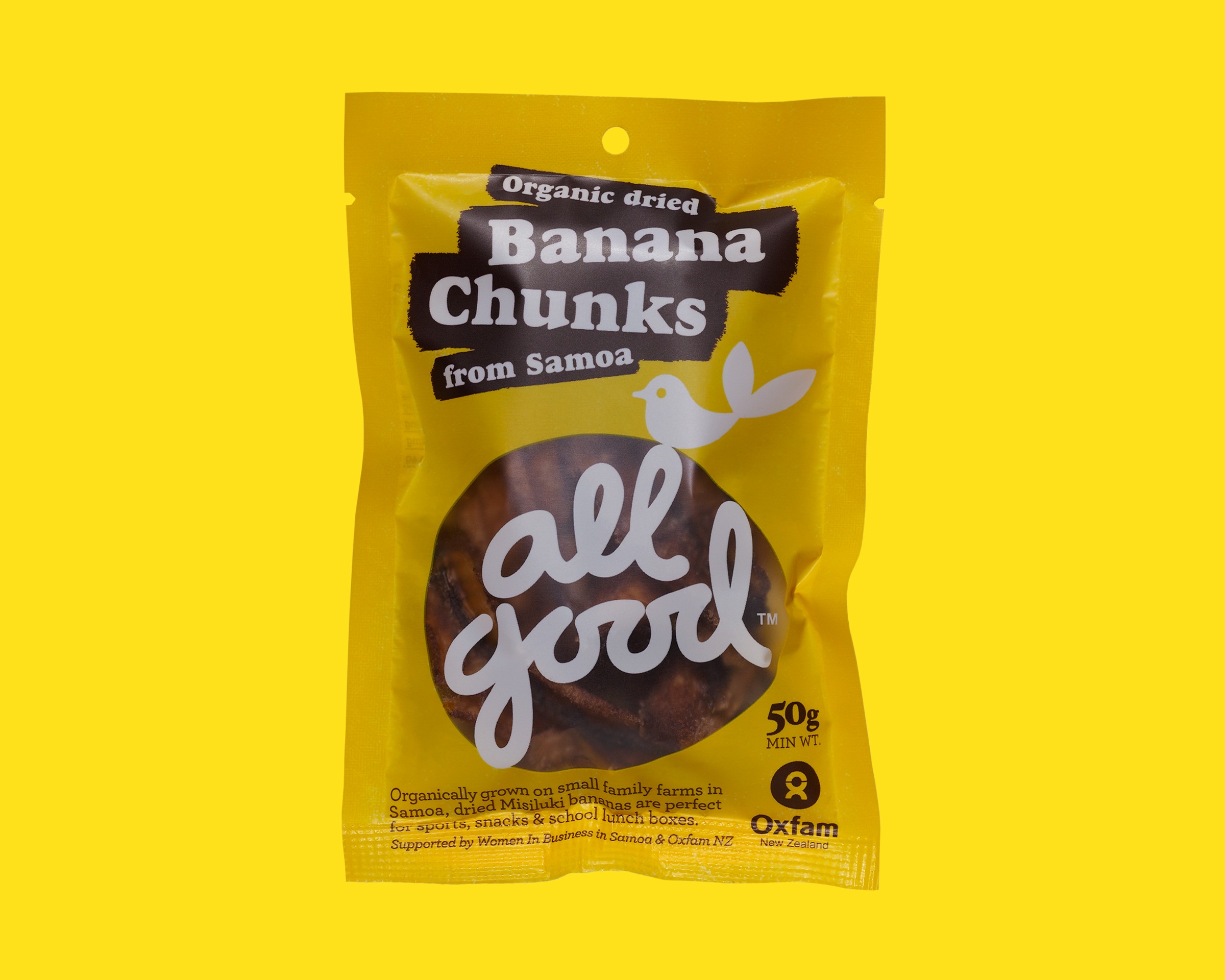 All Good Banana Chunks from Samoa — a yellow snack pack with the All Good logo, Oxfam partnership mark, on a yellow ground