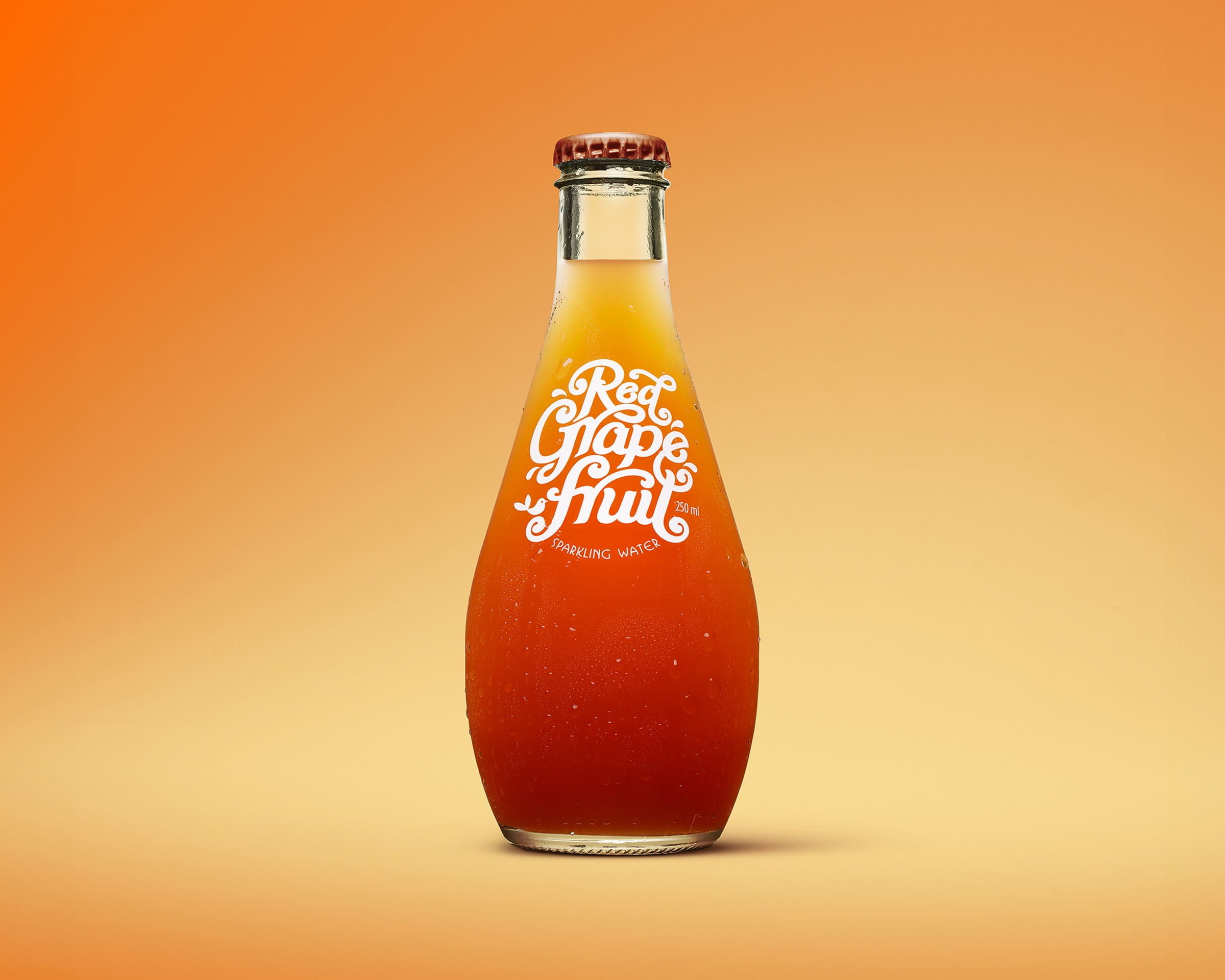 Red Grapefruit Flavour Bombs sparkling water, orange-to-red ombré liquid in a teardrop bottle on a saturated orange gradient