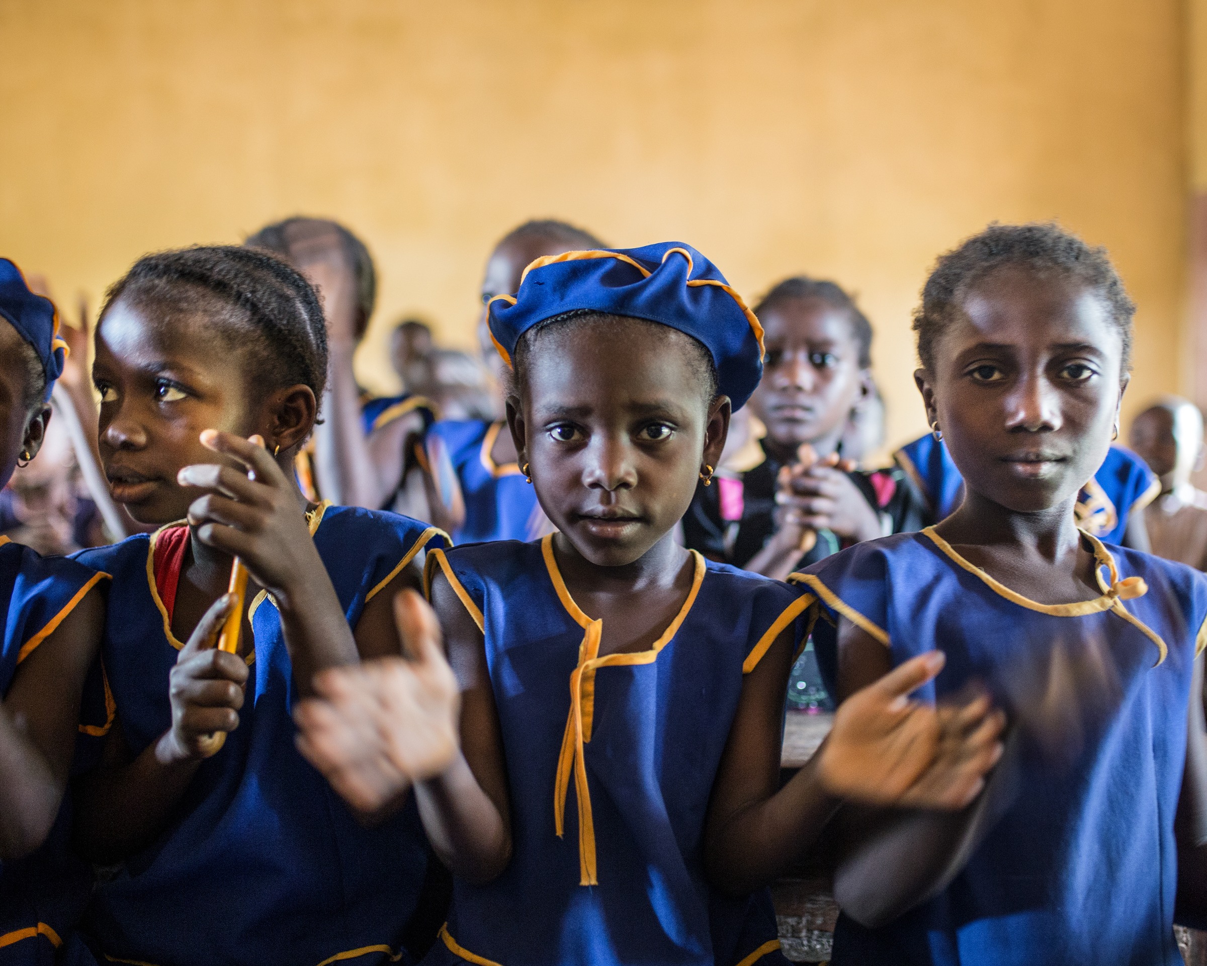 Schoolgirls in a classroom in Sierra Leone, their education made possible by The Karma Cola Foundation's scholarships.